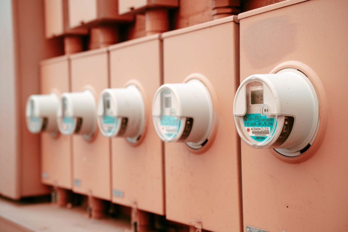 Technician checking electrical readings on an inverter installation