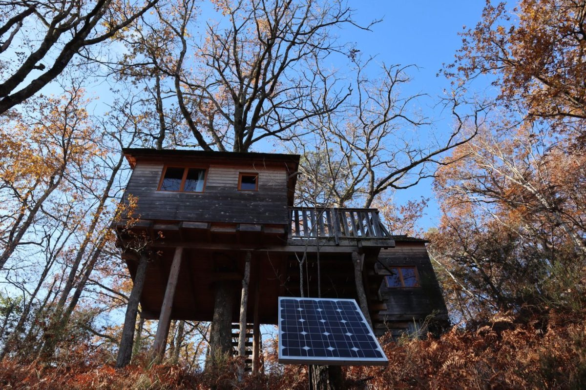 Off-grid solar power system with panels and battery bank at a rural home