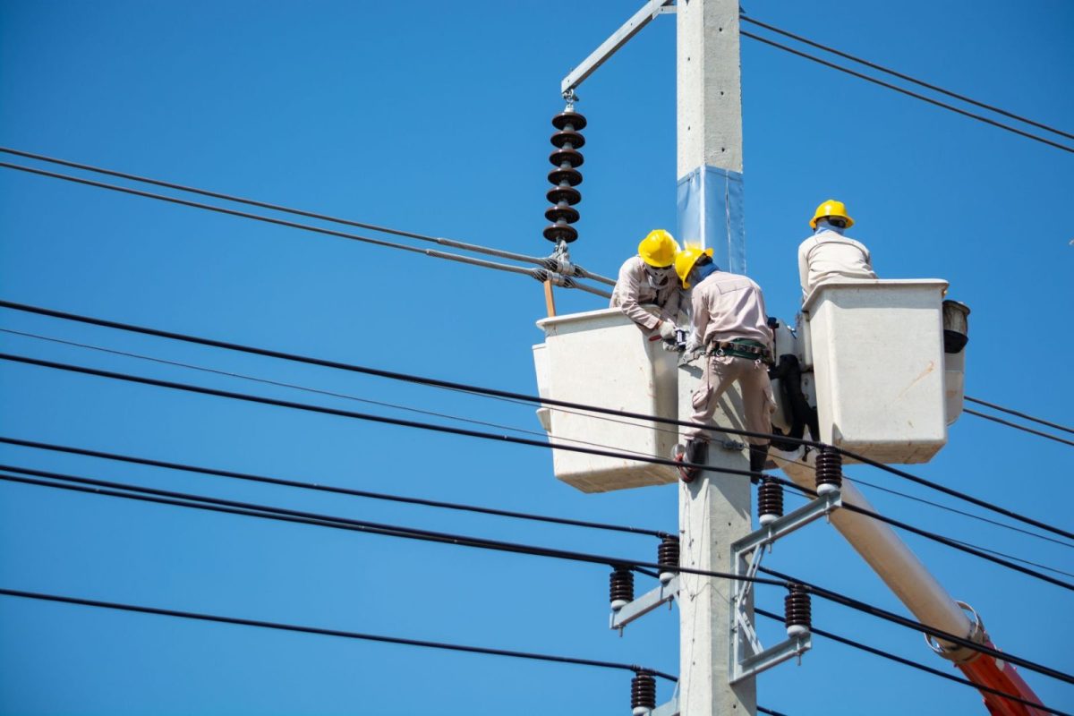 Technician checking solar system voltage with a meter