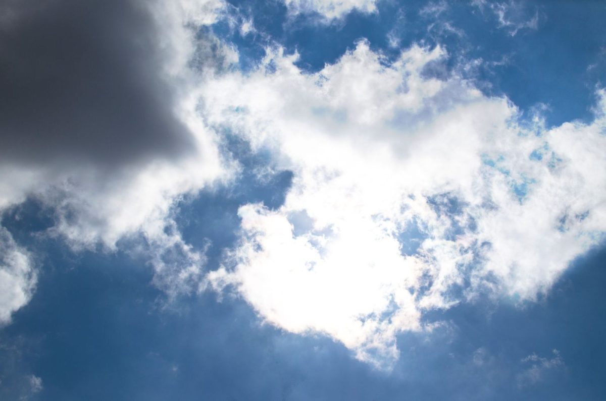 Bright sun and clear sky over a rooftop solar installation