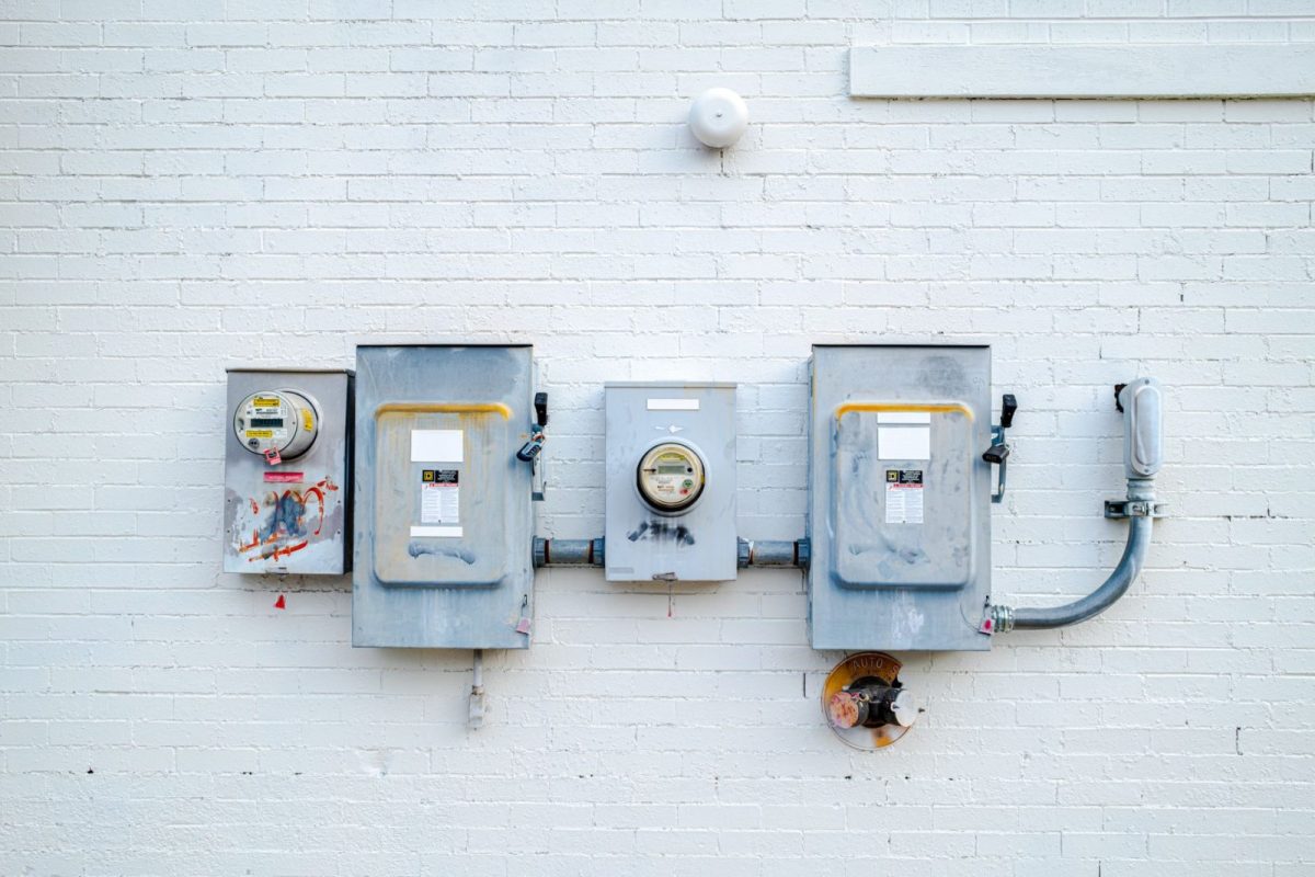 Electrician checking an electricity meter and inverter connection