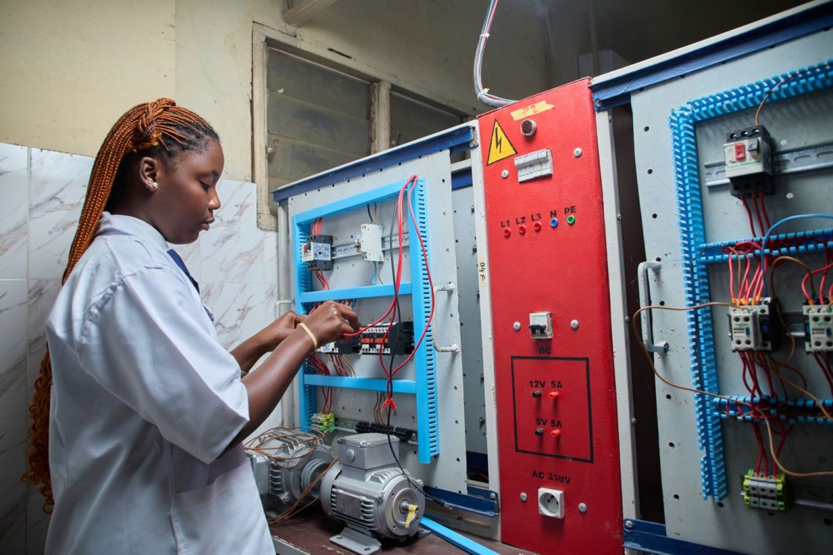 Technician checking an inverter and electrical panel