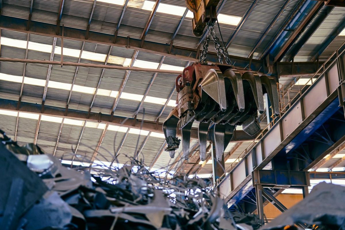 Worker sorting solar panel components for material recovery at a recycling facility