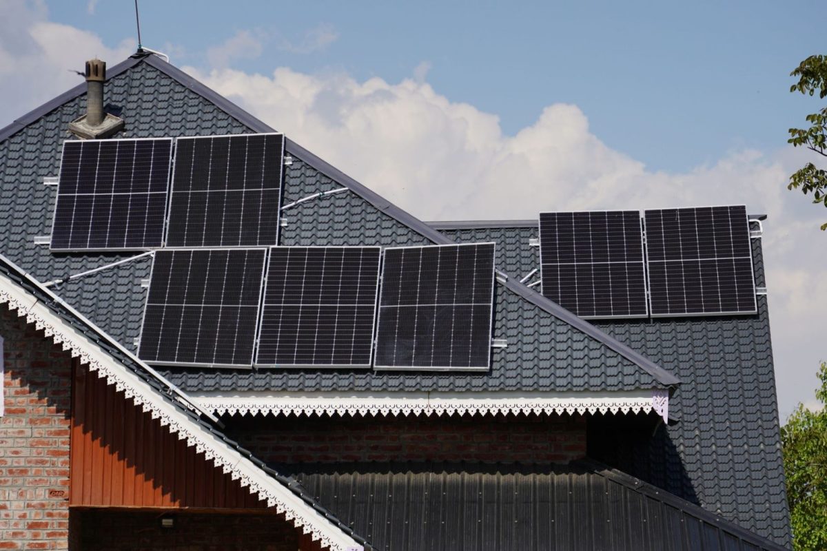 Rooftop solar panels with microinverters under each module