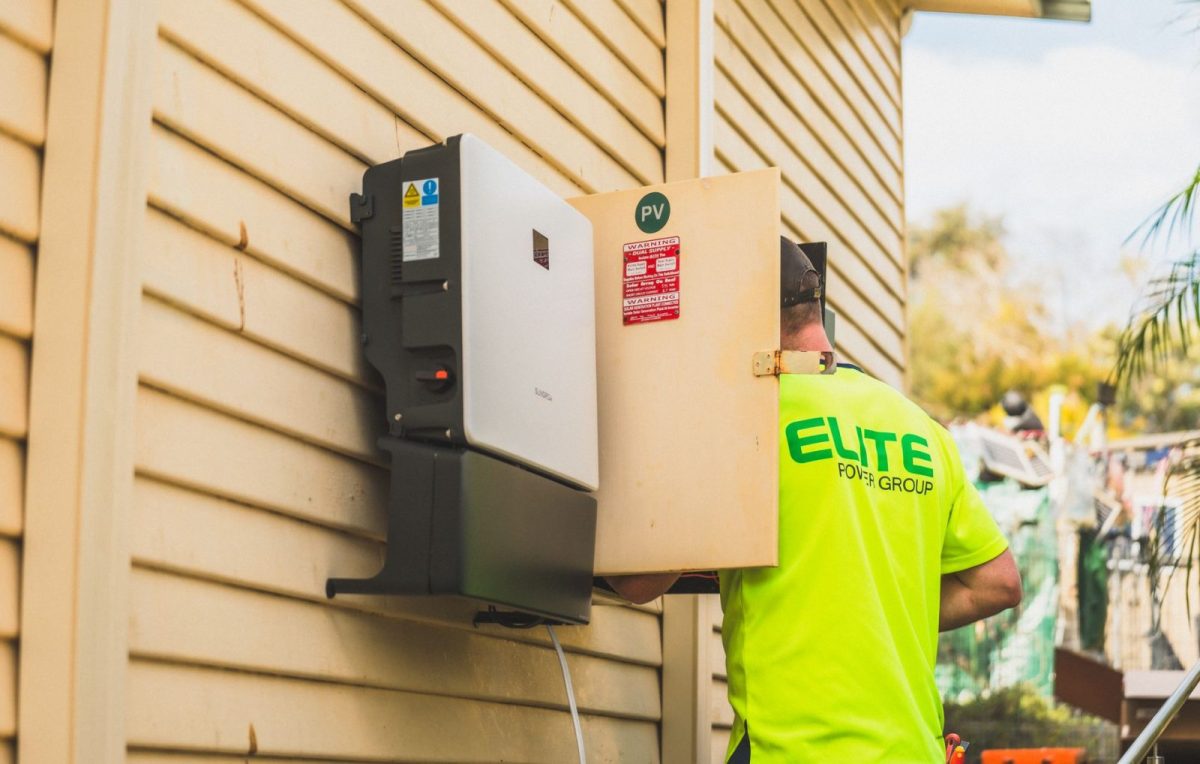 Wall-mounted string solar inverter on a residential wall