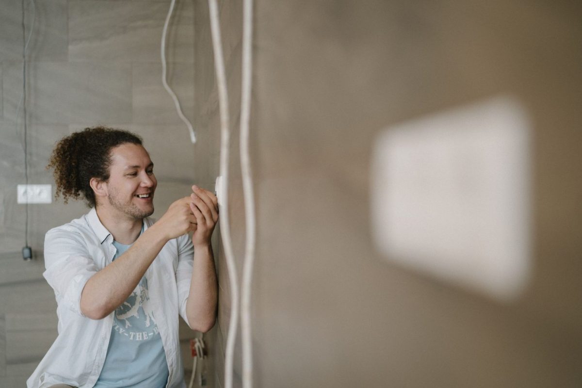 Electrician wiring an inverter during installation