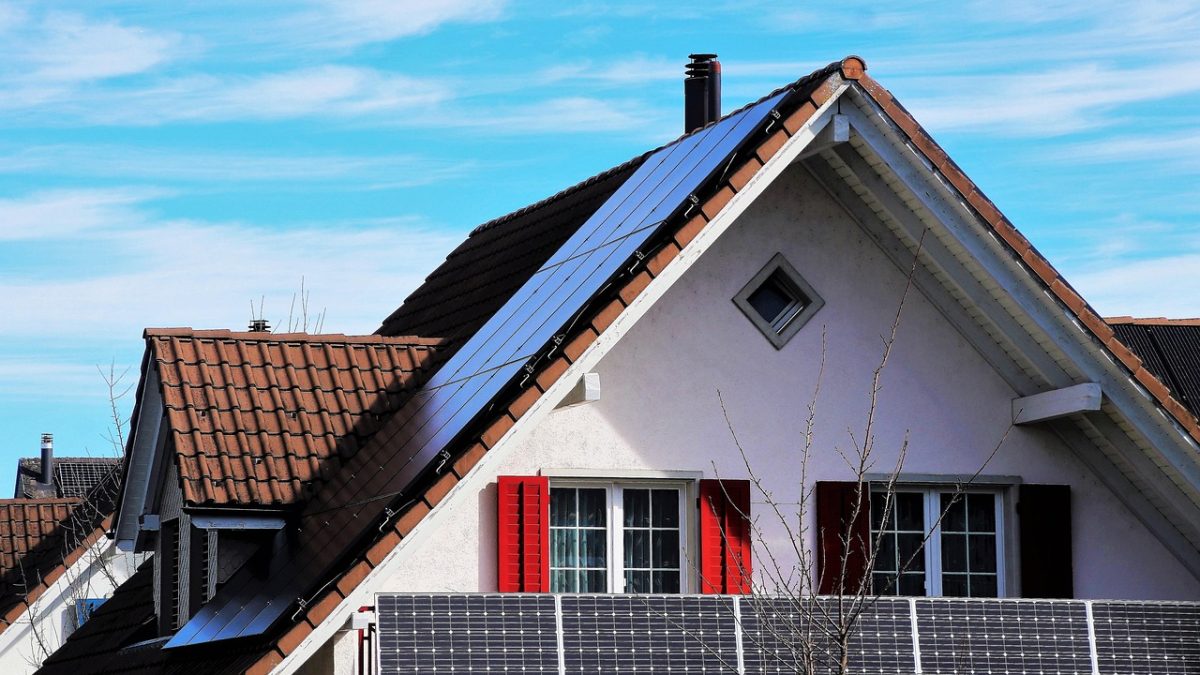 Rooftop solar panels under clear sky feeding a home system